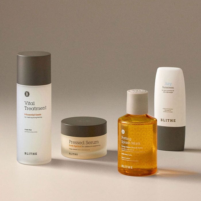 the four products in Blithe Cosmetics’ Pigmentation Relief Set on a beige surface