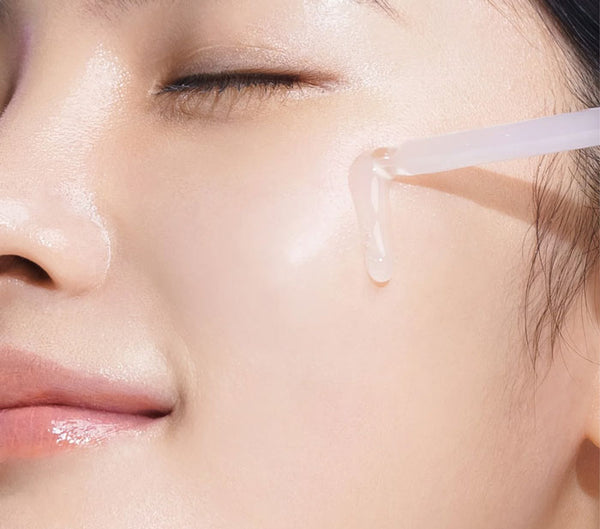 A woman applying Inbetween Essence Primer to her face