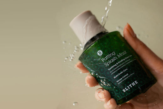 a patting splash mask being held under a stream of water