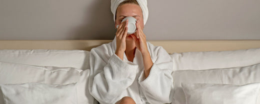 Image of a woman drinking water, symbolizing the importance of hydration for maintaining a healthy, radiant skin barrier as part of an overall skincare routine.