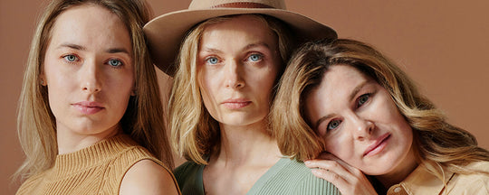 Three women of different ages, each representing a distinct age group, showcasing their radiant and well-cared-for skin, embodying the essence of skincare across generations.