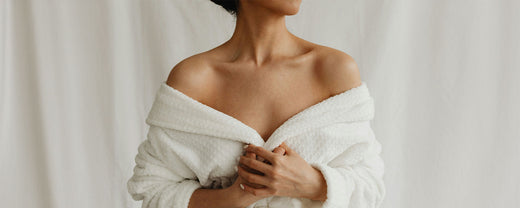 Close-up of a woman in a bathrobe, illustrating the importance of a gentle skincare routine for repairing the moisture barrier and hydrating dry skin.