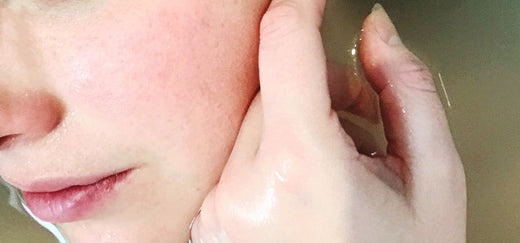 A detailed close-up image of a woman's face, capturing her serene expression and the natural beauty and texture of her skin, reflecting a moment of calm and self-care.