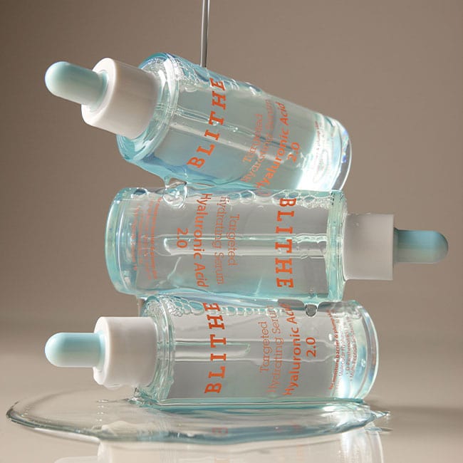 Three bottles of BLITHE Targeted Hydrating Serum Hyaluronic Acid 2.0 stacked together, highlighting the serum's deep moisturizing and skin-plumping benefits.