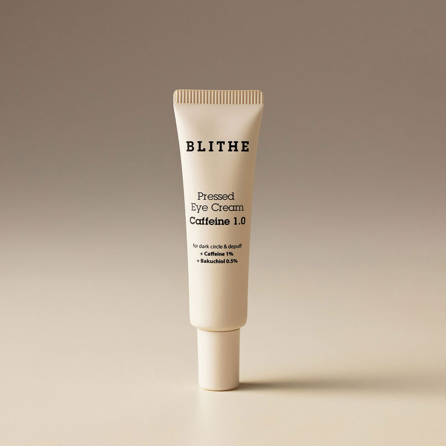 a tube of Blithe Cosmetics Pressed Eye Cream against a beige background
