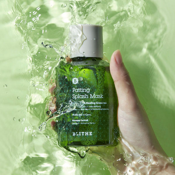 a hand holding a green Patting Splash Mask bottle in water