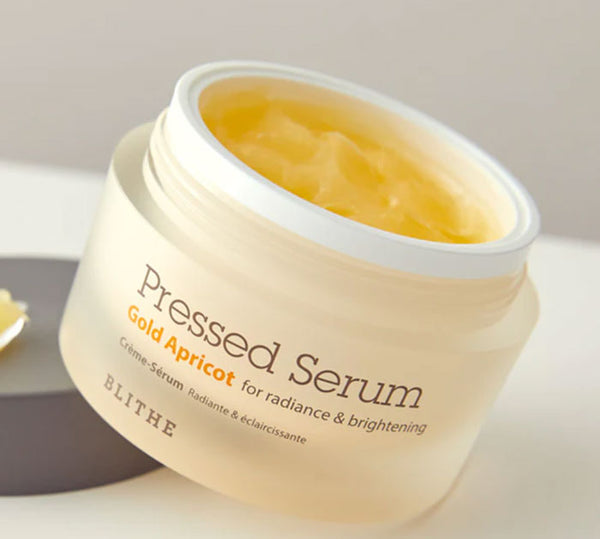 An open container of Pressed Serum - Gold Apricot