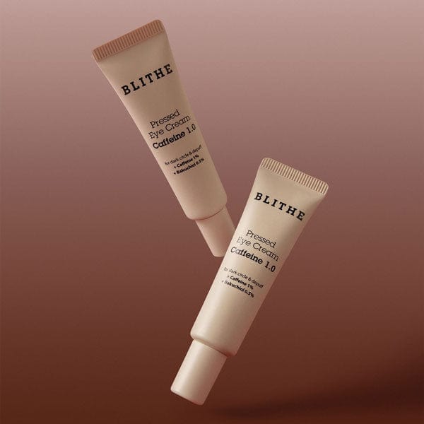 two Blithe Cosmetics pressed eye cream tubes against a brown background