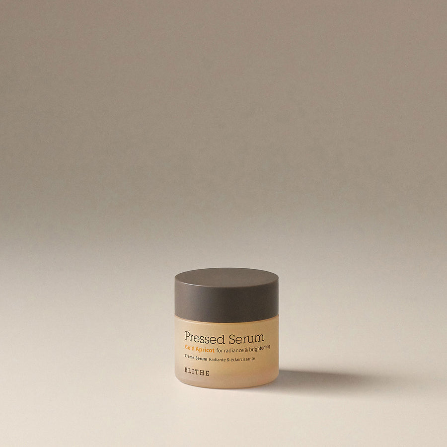 Pressed Serum Gold Apricot container on a surface