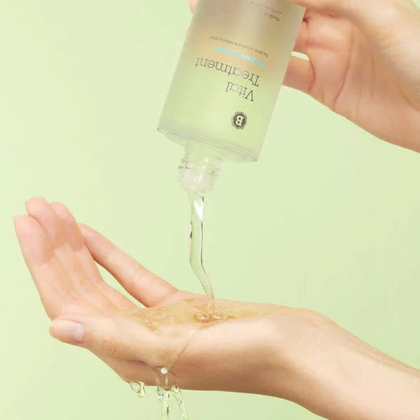 A woman pouring Blithe Vital Treatment 6 Calming Leaves. onto her hand